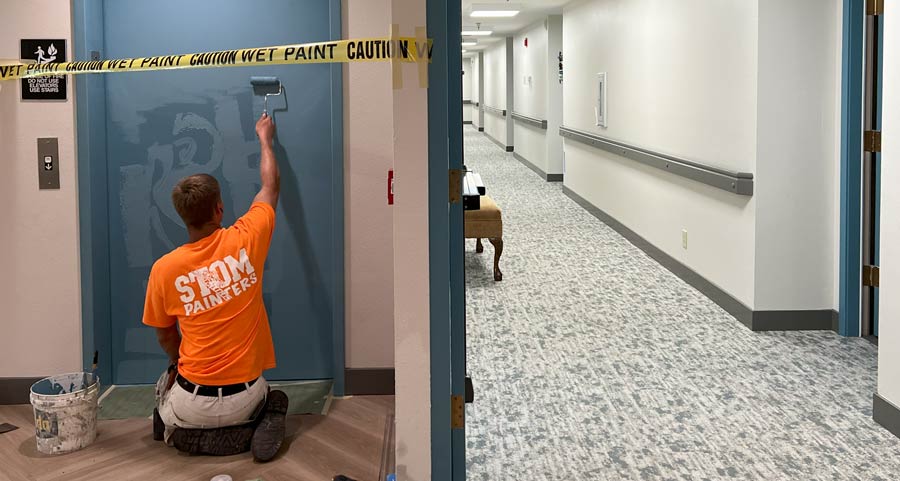 Stom Painters shown painting the interior of a commercial building