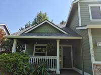 green-home-exterior-front-porch-painting
