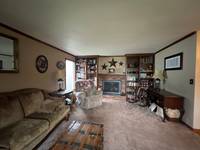 Dark walls and trim give the space a dated, closed-in feel, ready for a modern update.