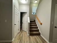 Fresh light gray walls and white trim brighten the space for a modern, open look.