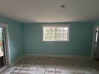 Sunlight pours in, casting a soft glow across the room and making it feel even more spacious