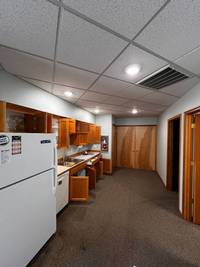 Fresh coat of paint on walls and ceiling created a clean and inviting atmosphere in the staff kitchen area.