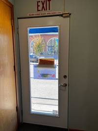 Back door area restored with updated paint and clear signage.