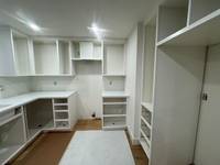 Wide view of the full built-in setup, highlighting the seamless and cohesive white finish.