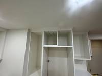 Close-up of upper shelving and cabinet areas with crisp lines and an even paint application.